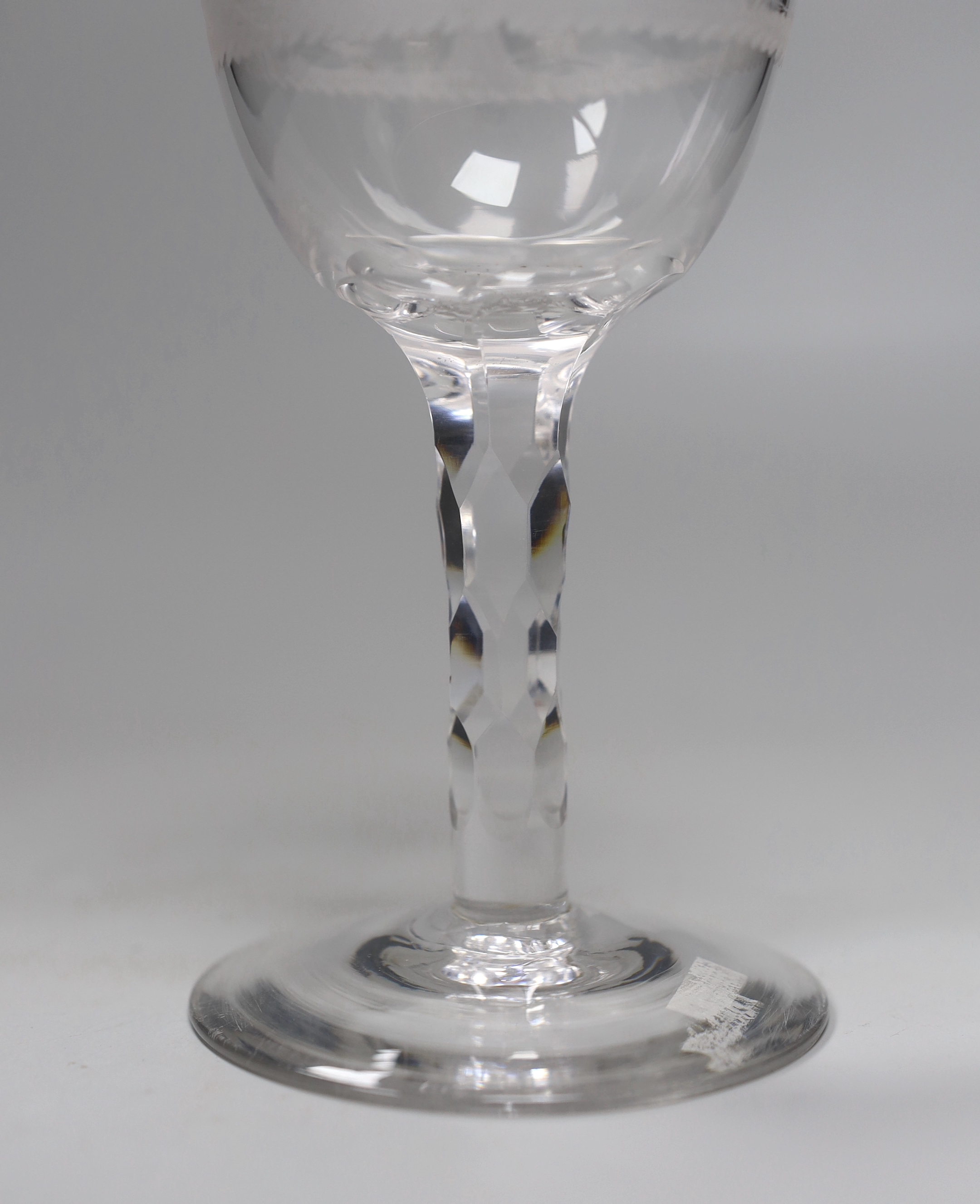 An English lead crystal facet stem goblet, c.1780, round funnel bowl, with hexagonal facet stem, conical foot, engraved in the round with trees and cock fighting scenes, 18.6cm